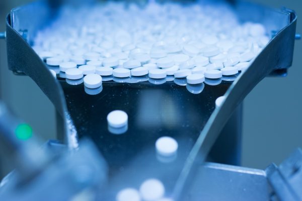 Heap of medicine pills in production, closeup.