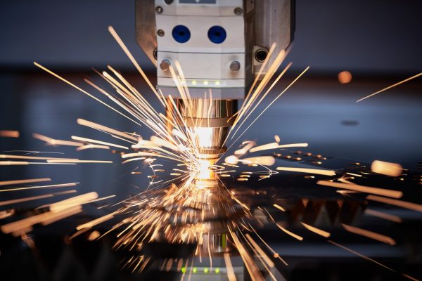 laser cutting. Metal processing on cnc laser machine with sparks